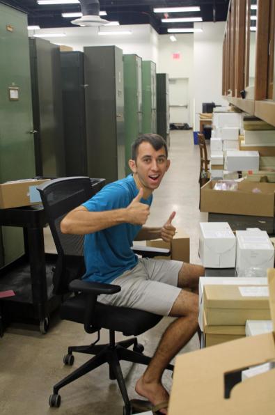 Student facing camera smiling with thumbs up