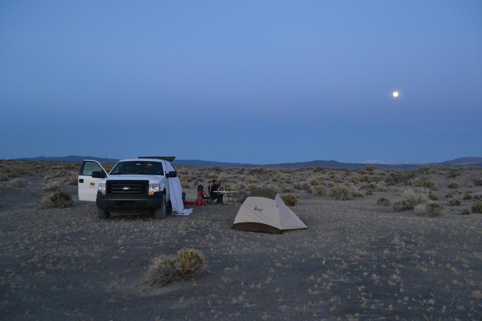 ASU Graduate Students camping on Nevada Sand Dunes at dusk